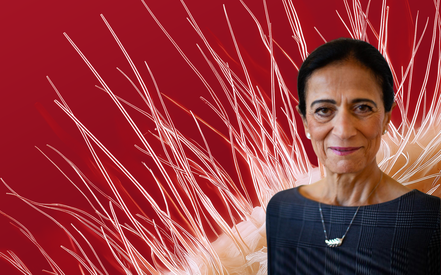 A middle-aged woman with dark hair pulled back, wearing pearl earrings and a dark checkered top, is positioned on the right side of the image. She has a subtle smile and wears a necklace with a distinctive pendant. The background is a deep red with abstract white and orange lines radiating outward, resembling stylized plant or fiber structures.